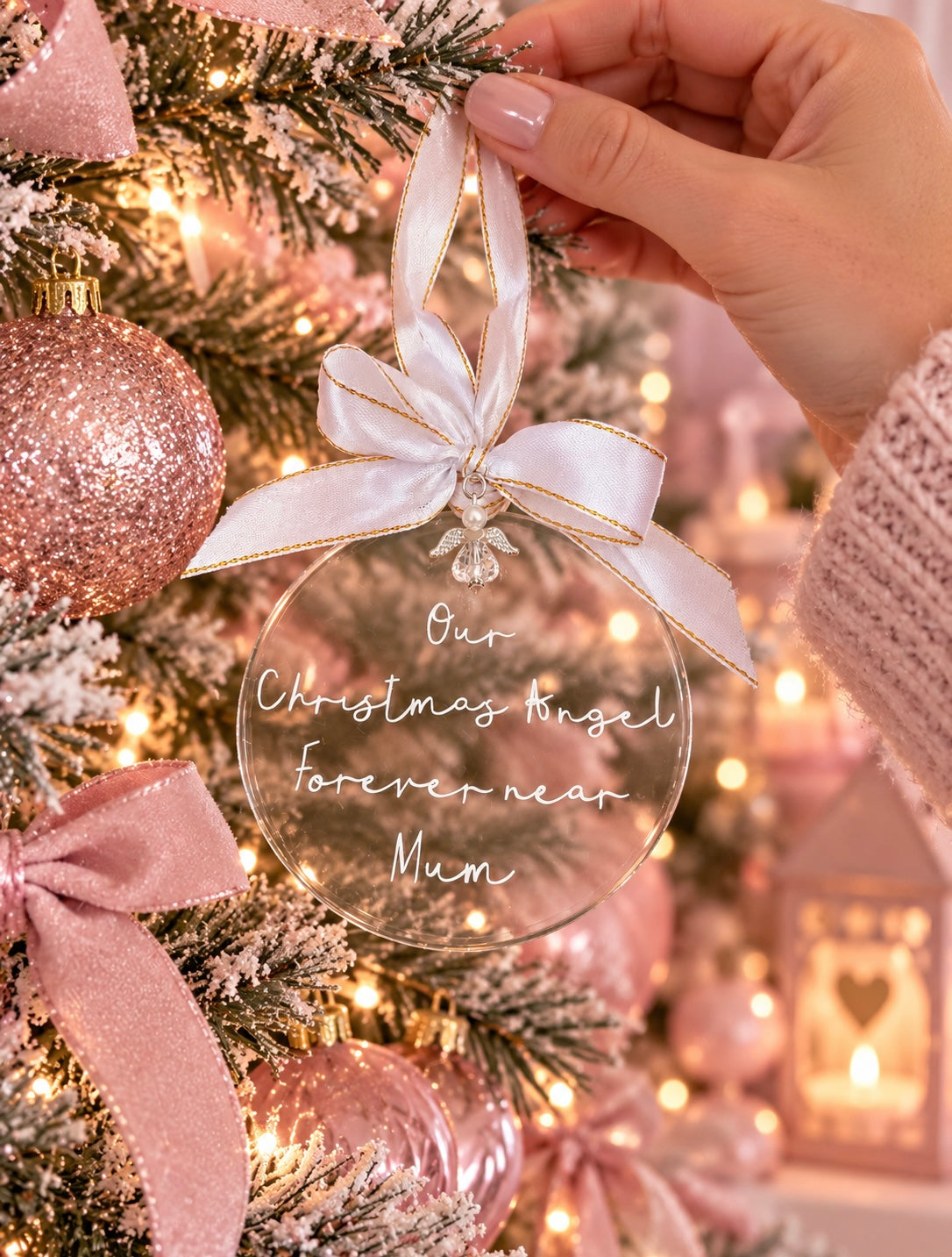 Clear acrylic memorial bauble saying Our Christmas Angel forever near Mum