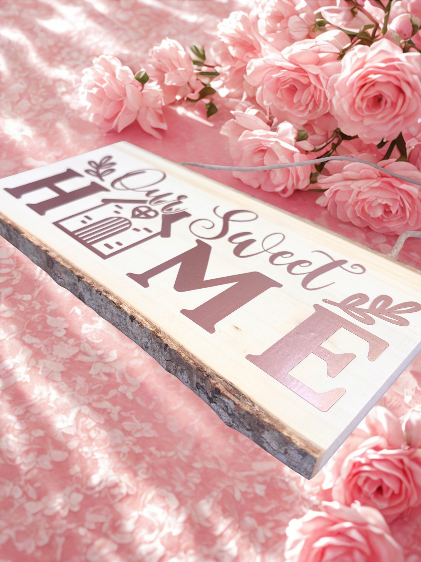 Decorative sign with 'Our Sweet Home' text on a pink floral background