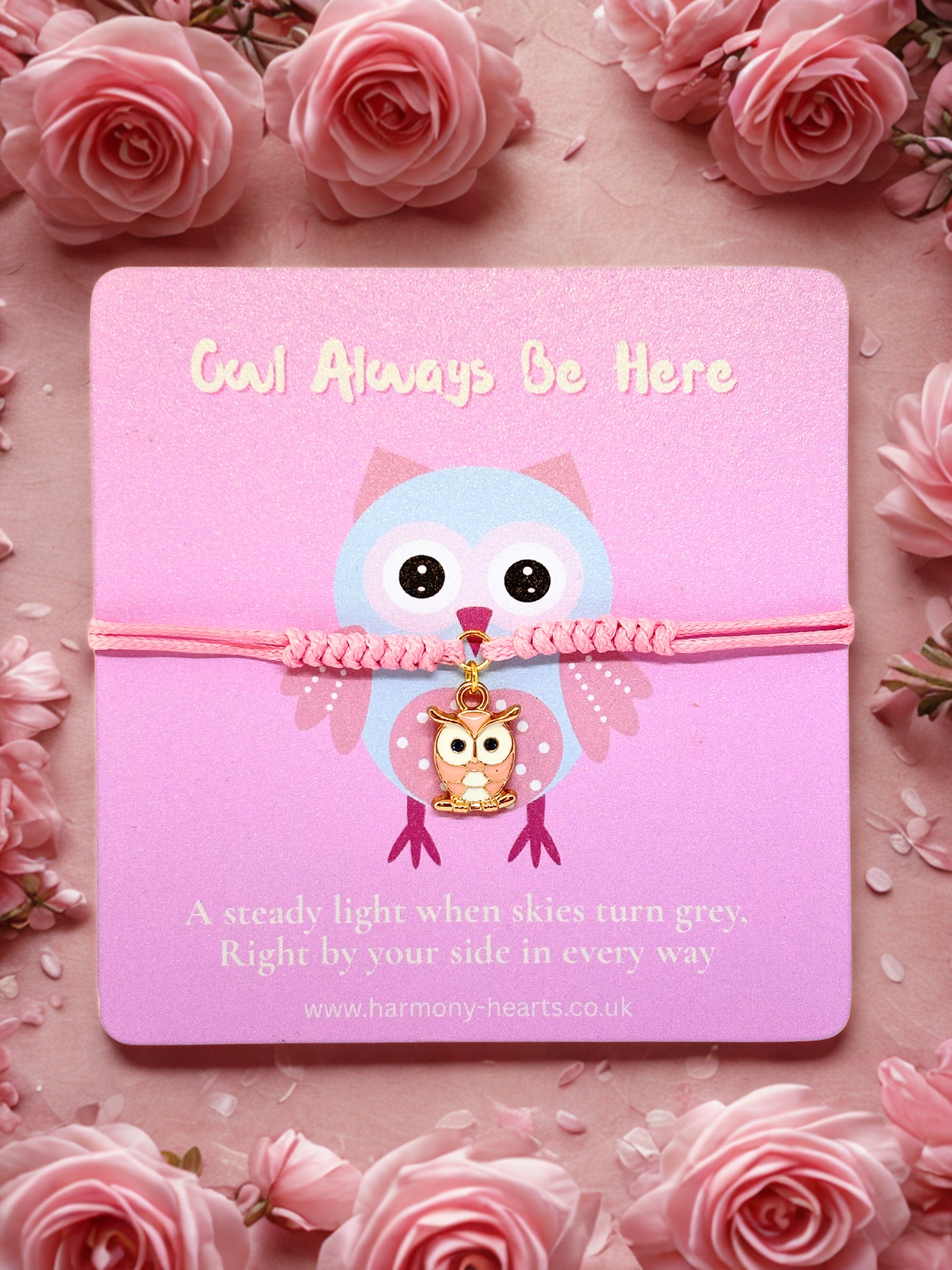 Pink cord bracelet with an owl charm presented on a branded Harmony Hearts card on a pink background