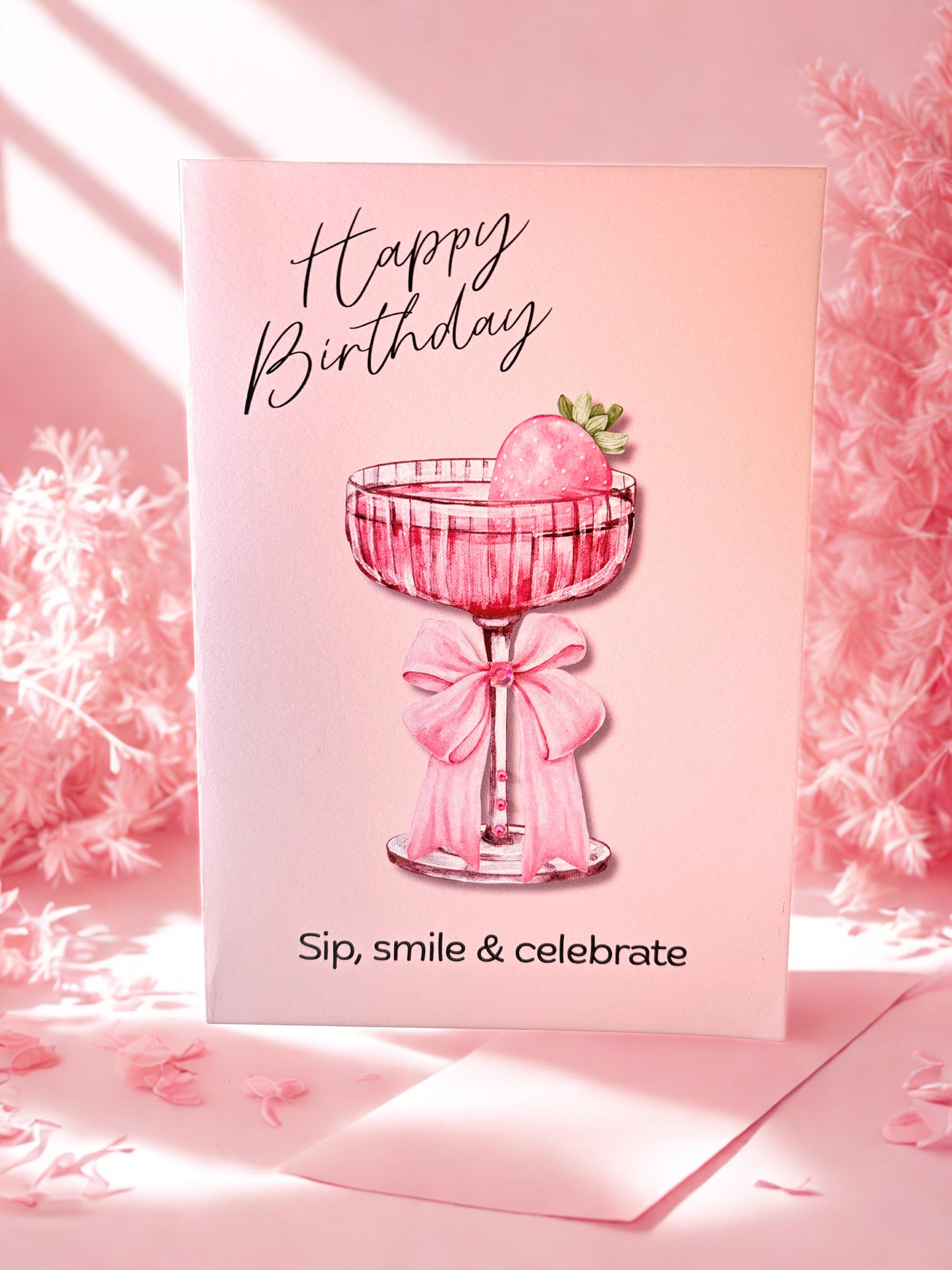 Greeting card with a pink cocktail and birthday message on a pink background