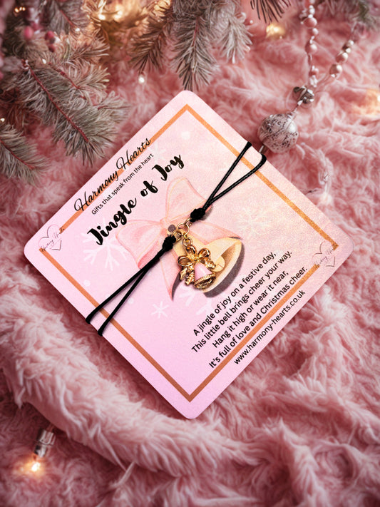 Jingle bell charm bracelet on a pink card with decorative background