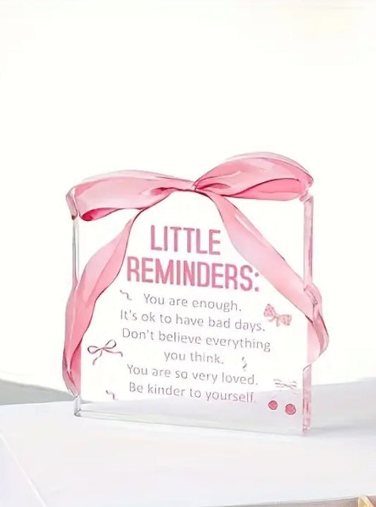 Acrylic block with pink ribbon and motivational text on a white background