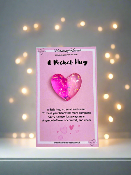 Pink card with a heart-shaped object and text on a blurred light background