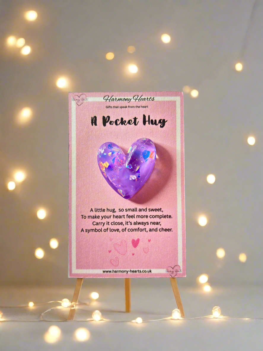 Heart-shaped purple object on a pink card with text, surrounded by string lights.