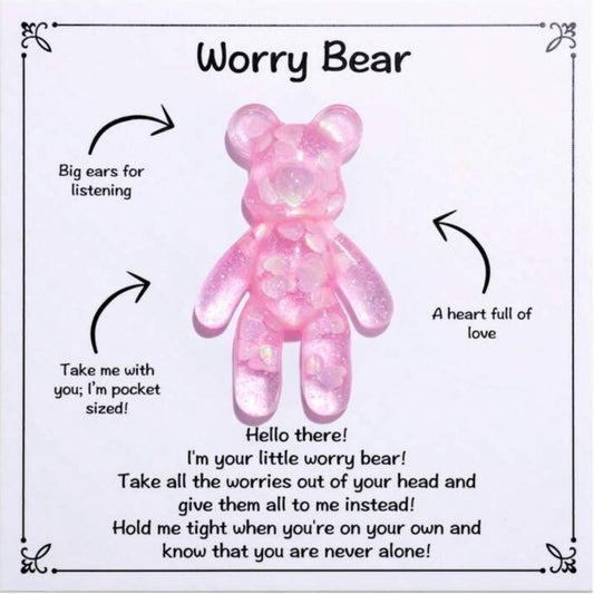 A pink, handcrafted resin bear with shimmer details, designed to be pocket-sized. It has big ears and is described as having a heart full of love.