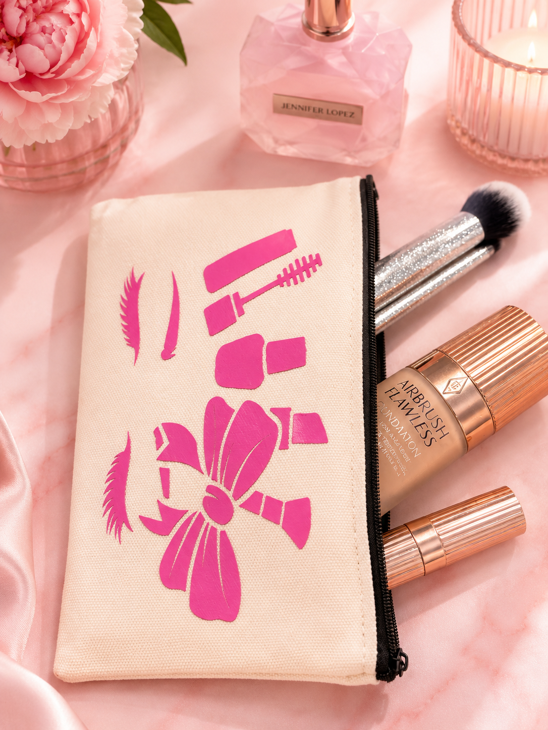Makeup bag with cosmetic items on a pink background