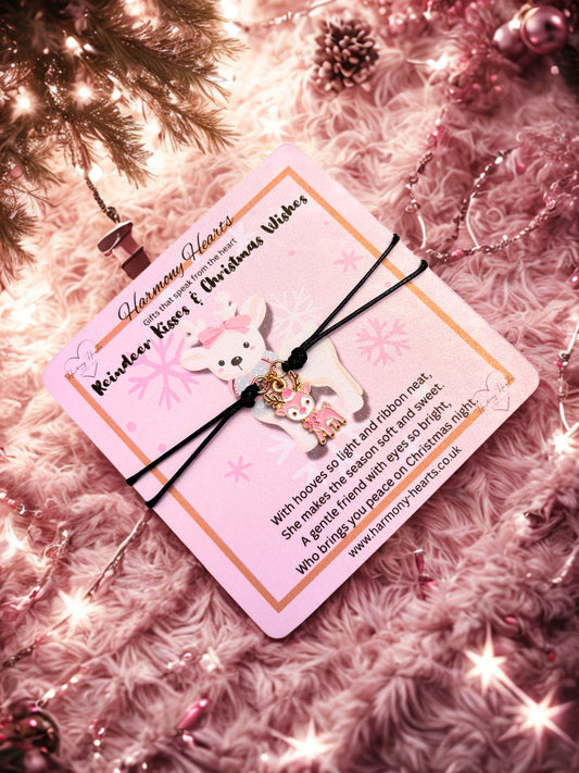 Bracelet with a reindeer charm on a pink card against a festive background