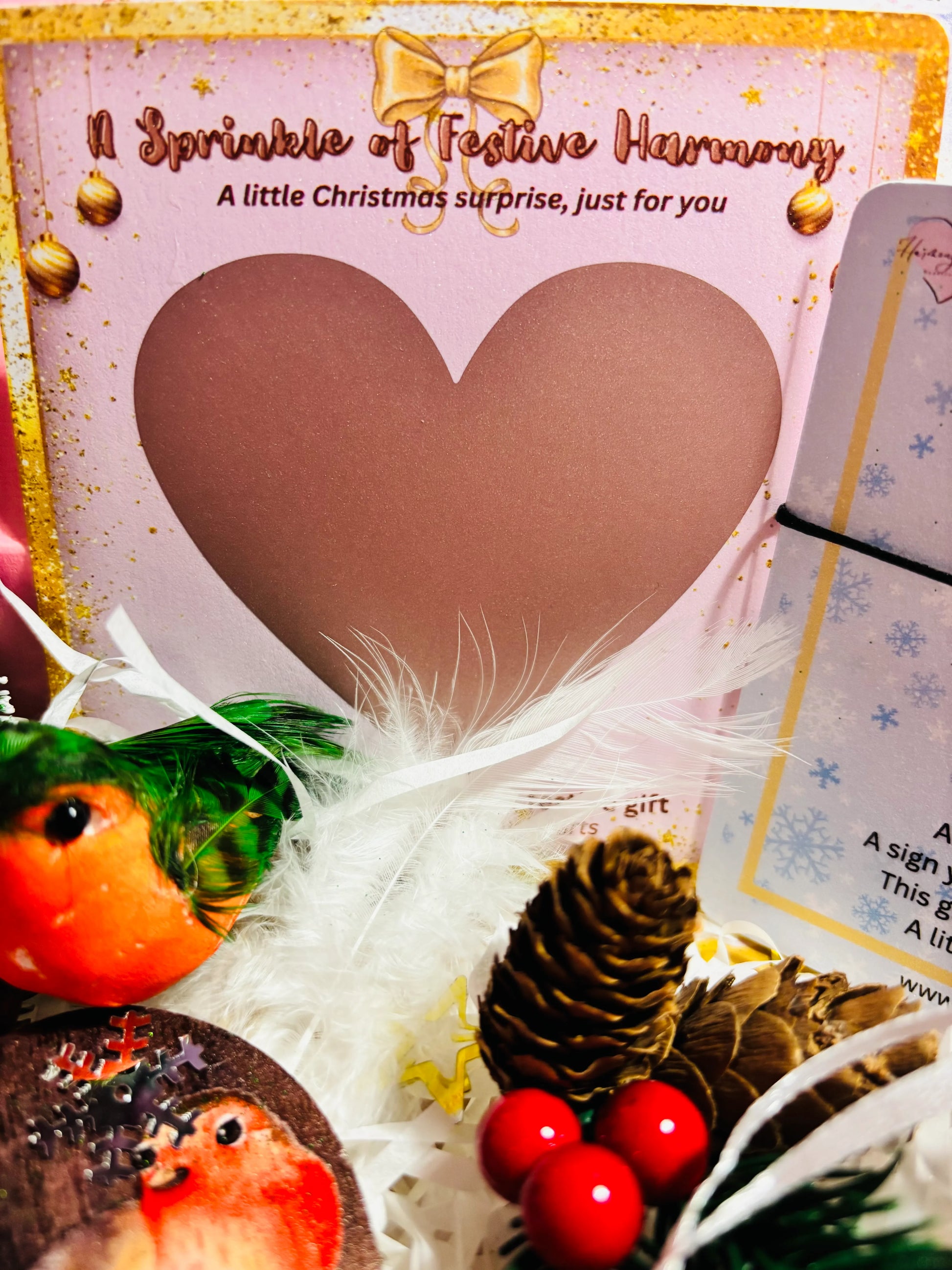 Decorative Christmas card with a heart design, festive elements, and text.
