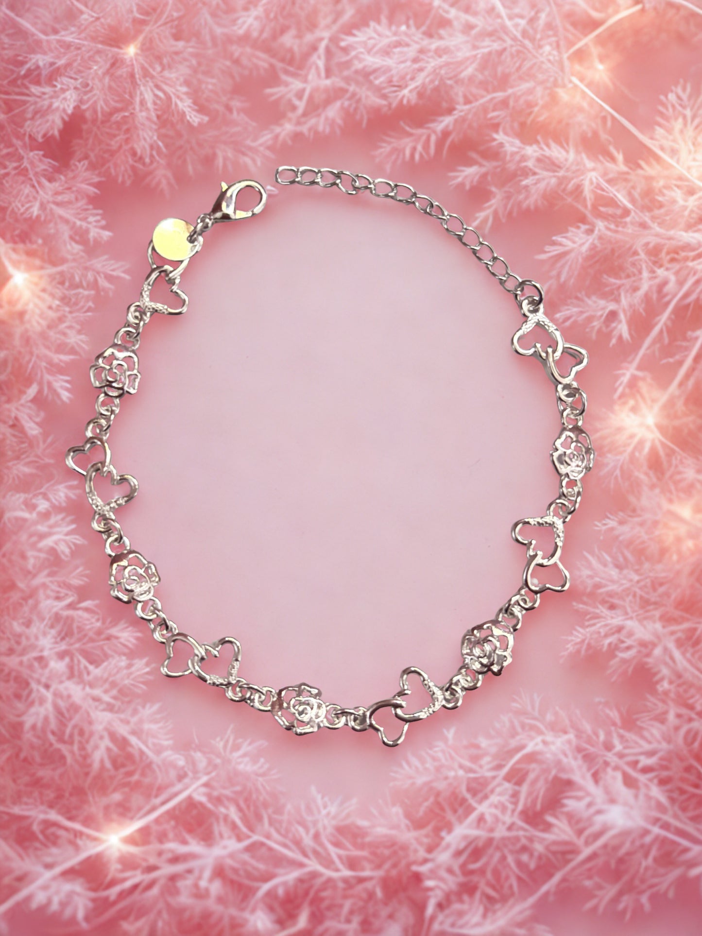Silver bracelet on a pink textured background