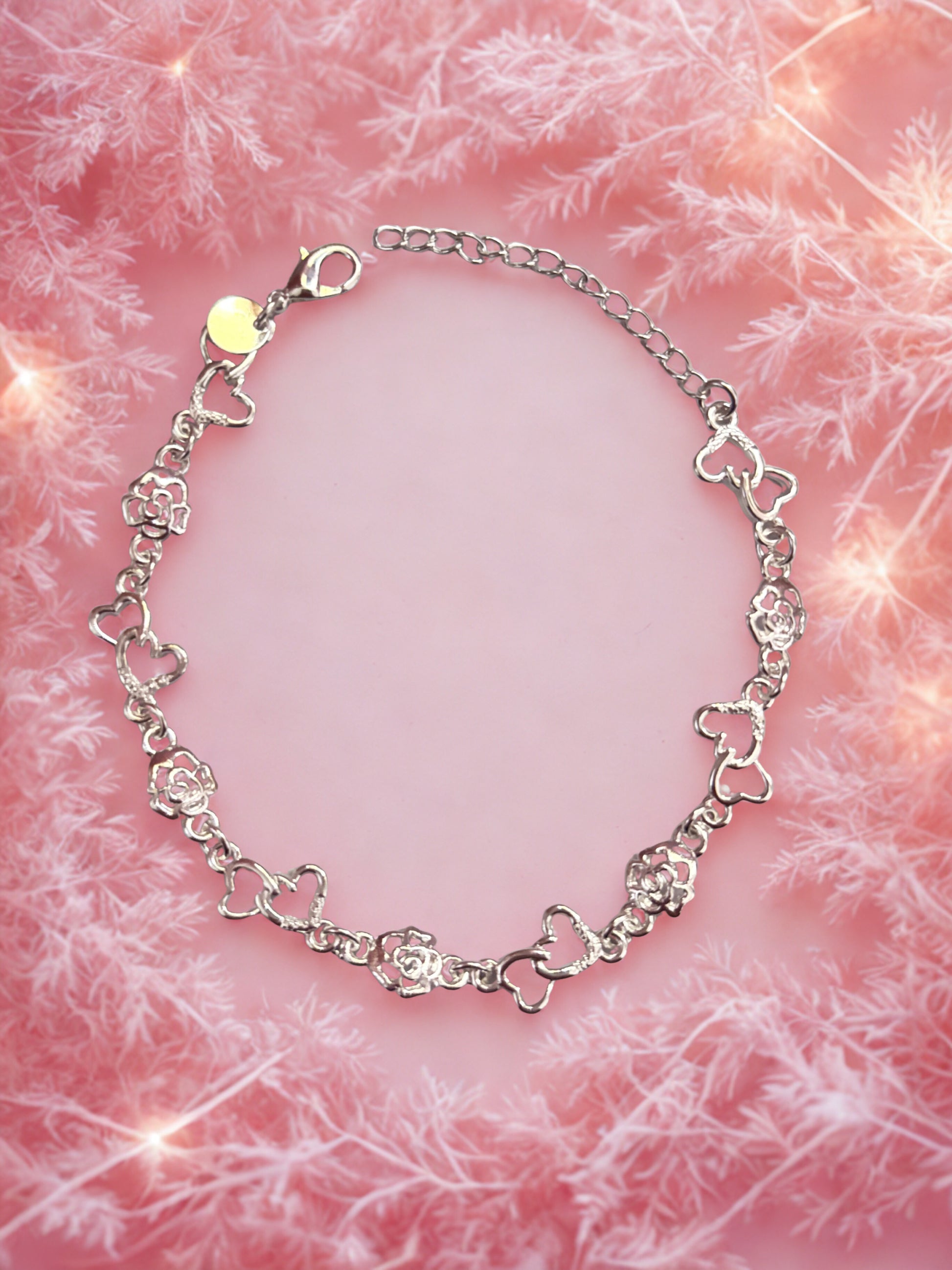 Silver bracelet on a pink textured background