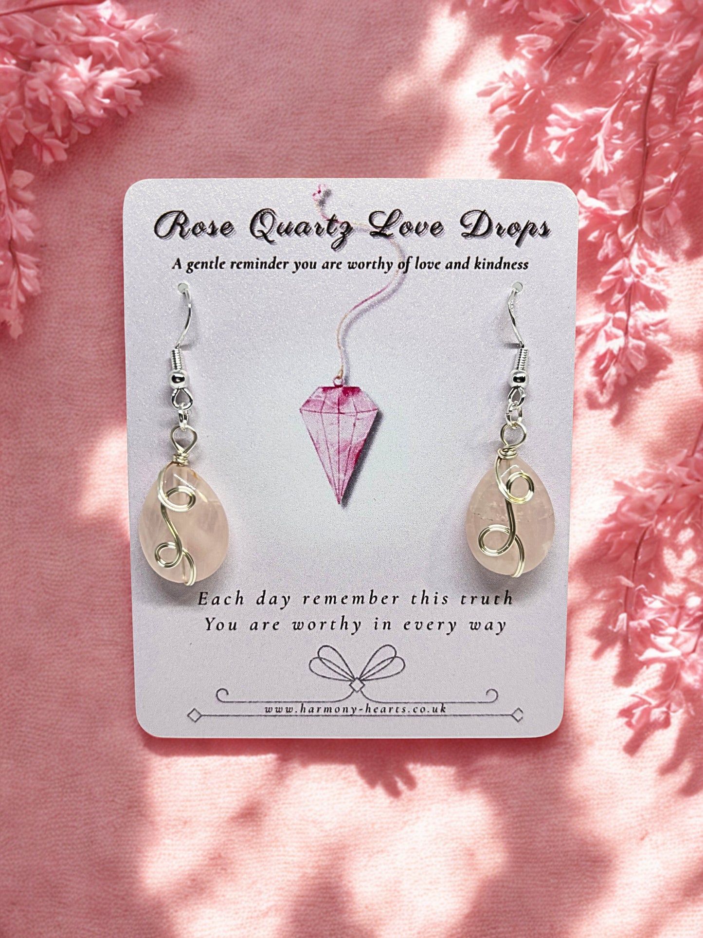 Rose quartz Earrings on a card with pink floral background