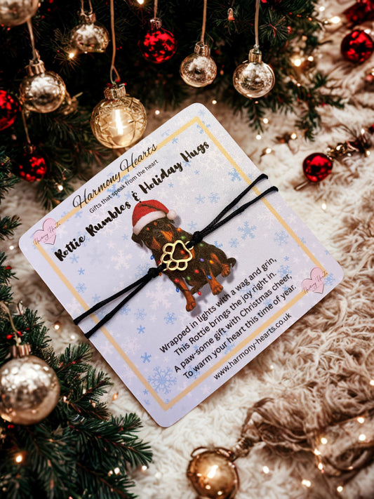 Rottie card with bracelet with paw print charm under a christmas tree