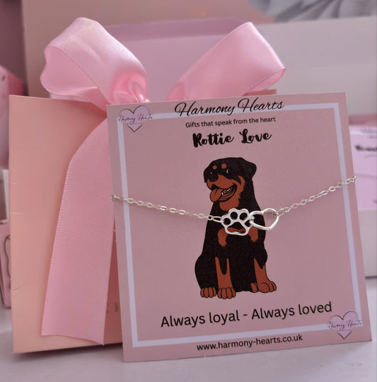 Bracelet with dog illustration on a pink card with 'Harmony Hearts' branding.