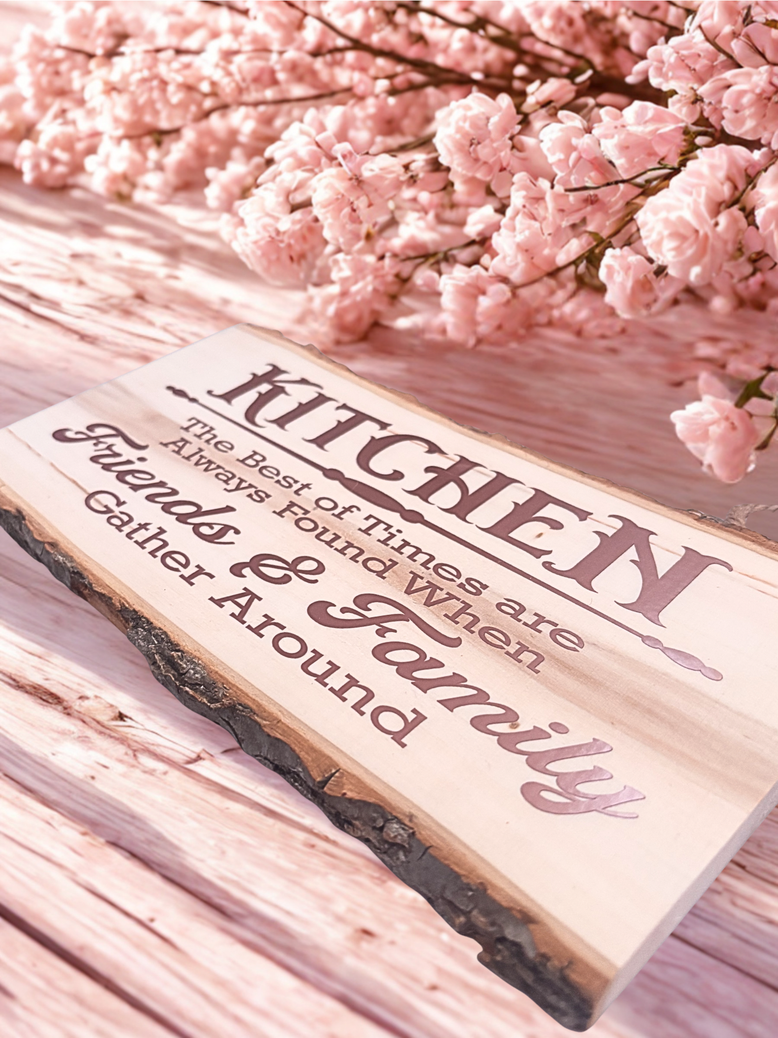 Wooden sign with decorative text on a pink floral background