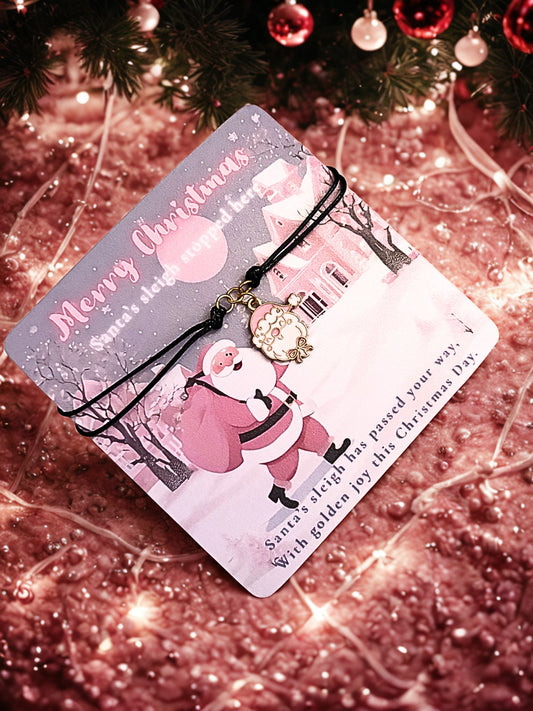 Christmas card with Santa Claus design and a santa charm bracelet on a glittery background