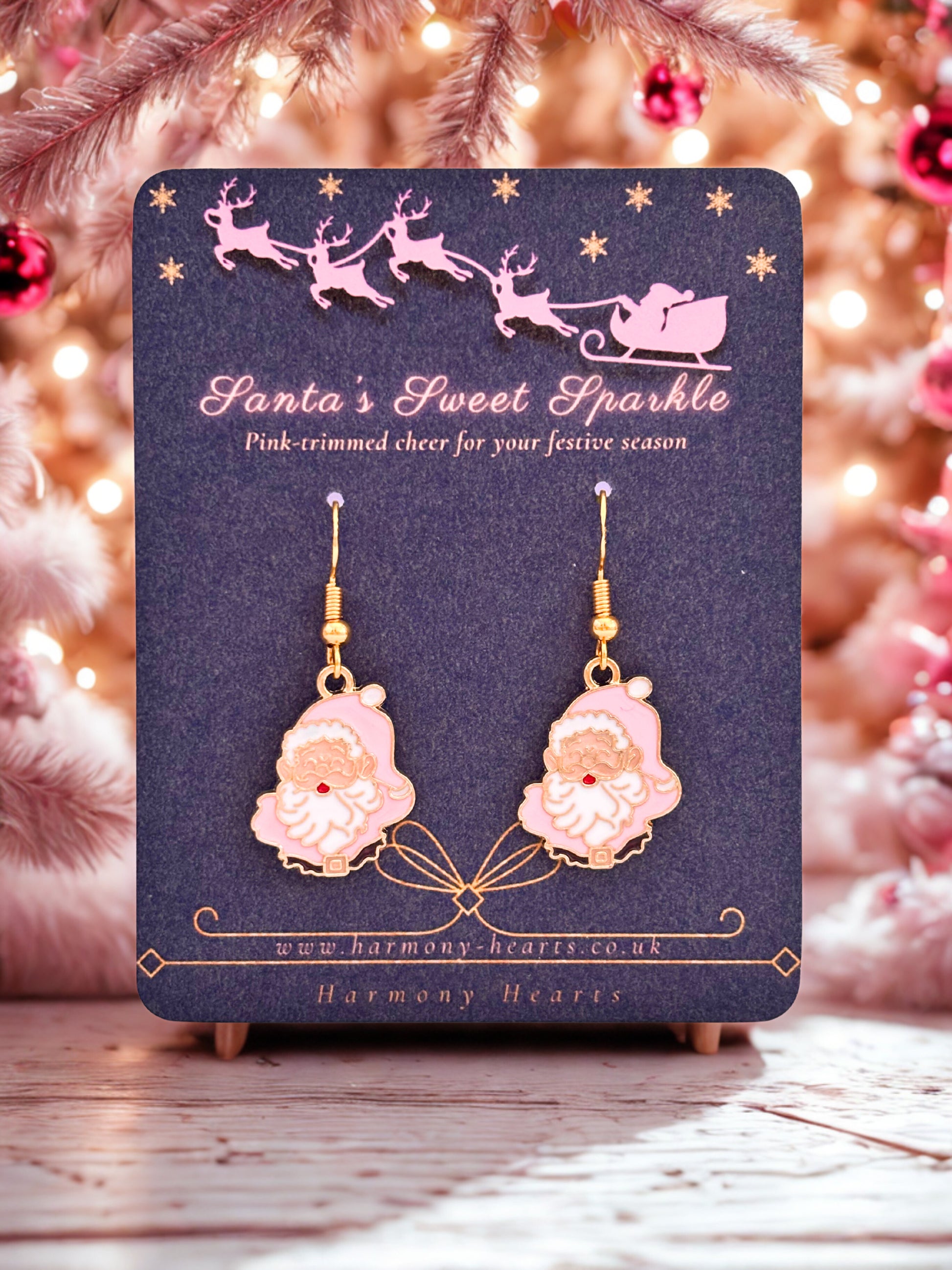 Pink Santa Claus earrings on a 'Santa's Sweet Sparkle' card with a festive background.
