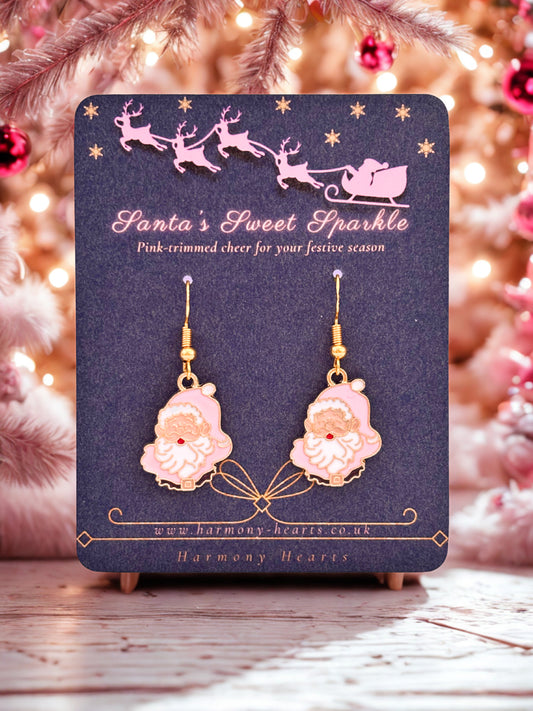 Pink Santa Claus earrings on a 'Santa's Sweet Sparkle' card with a festive background.