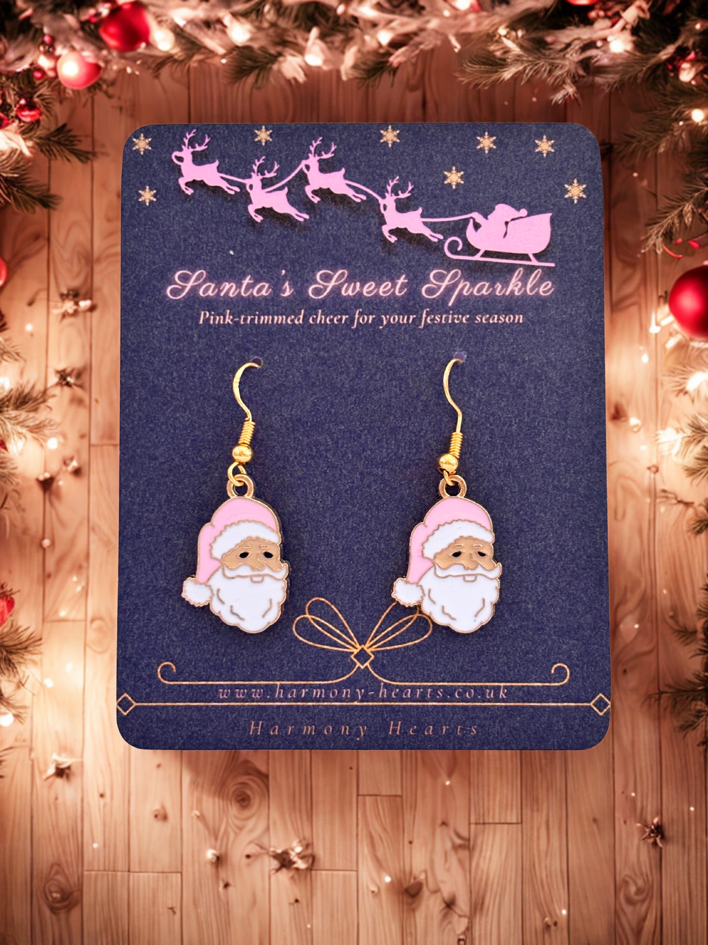 Santa-themed earrings on a branded card with Christmas decorations in the background