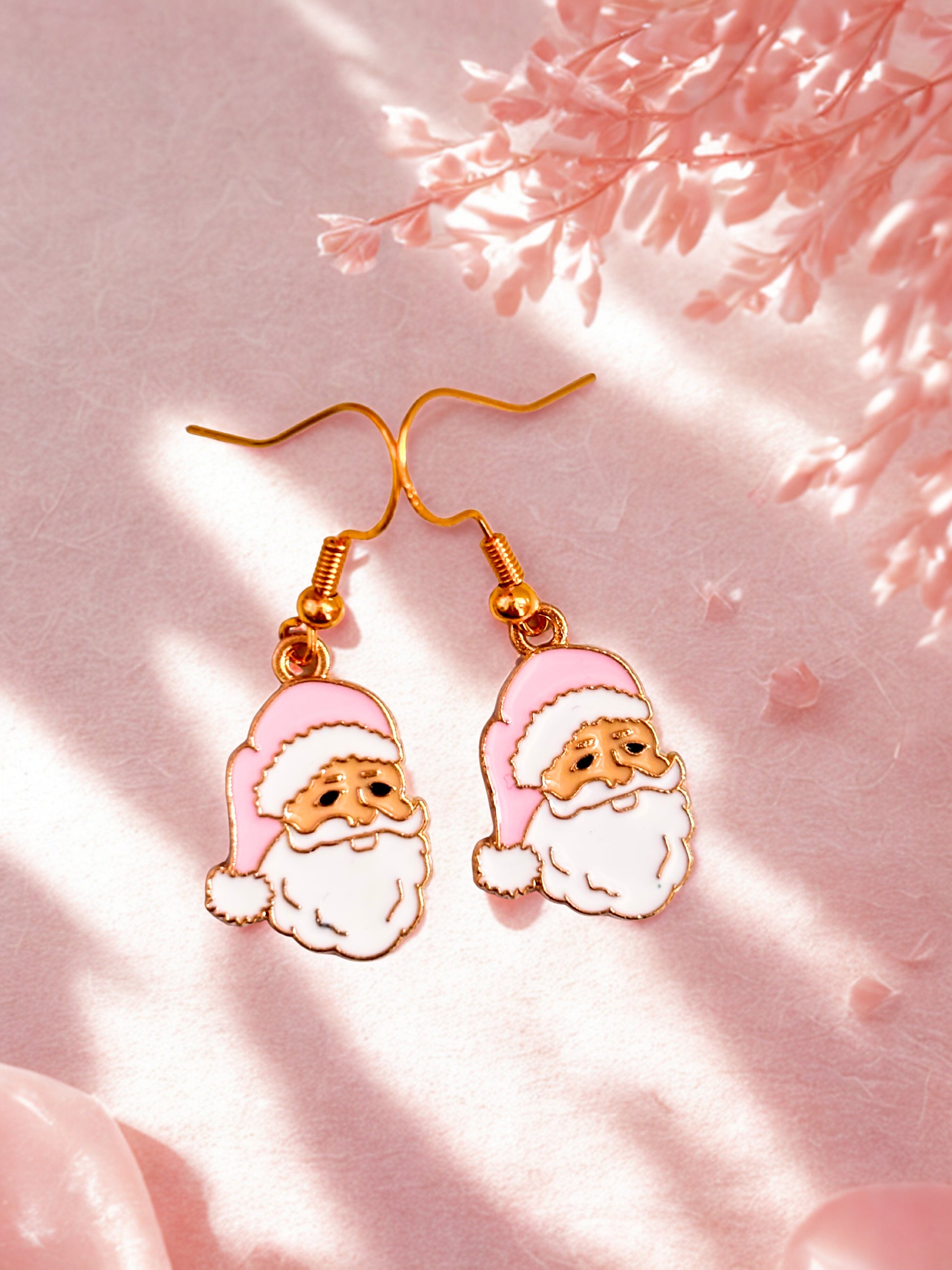 Santa Claus earrings on a pink background