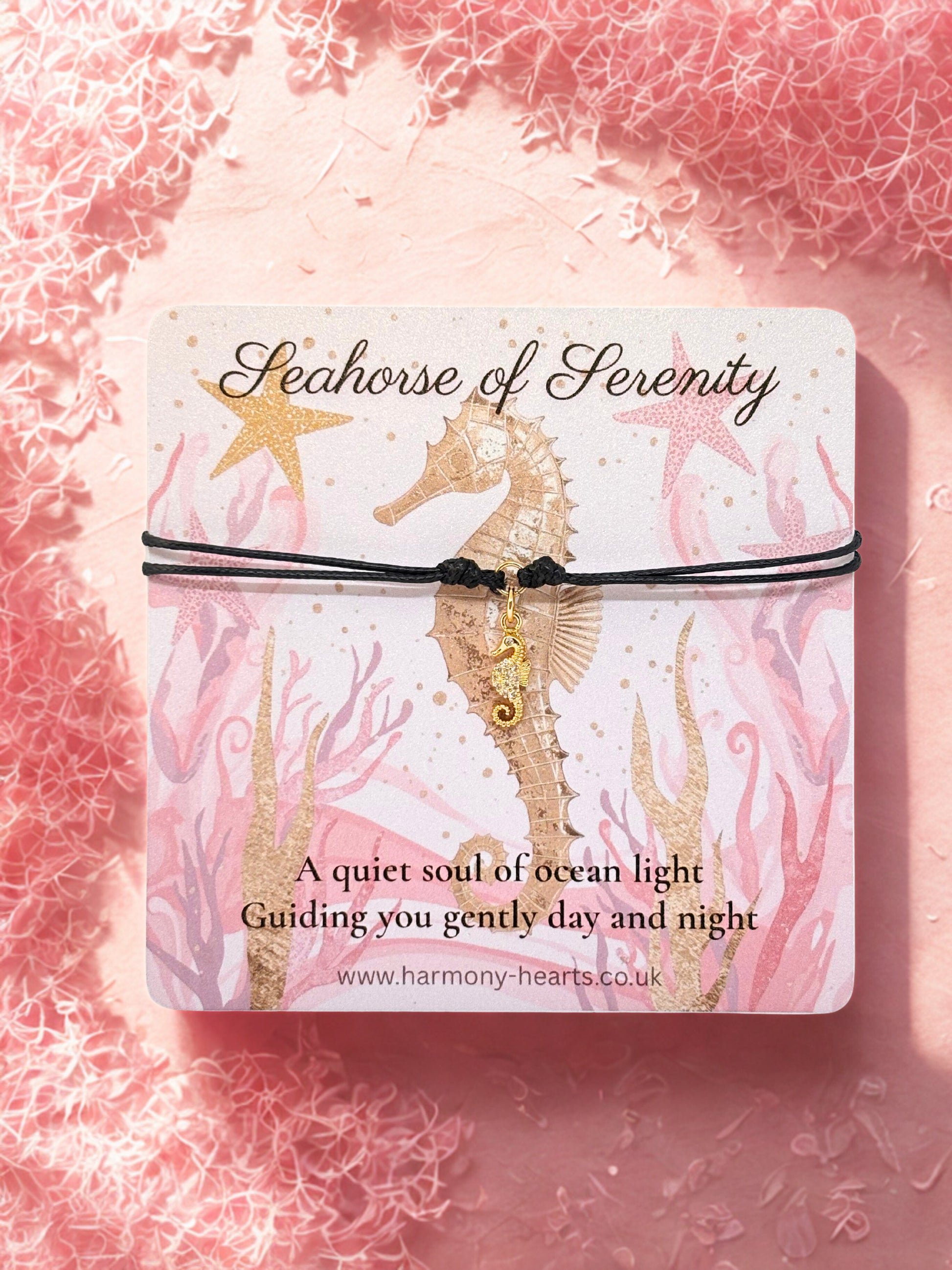 Seahorse charm bracelet with seahorse design card and text on a pink textured background