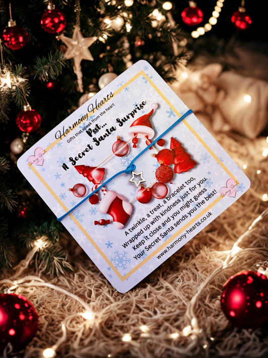 Secret Santa gift tag with red ribbons and Santa hats on a Christmas tree background