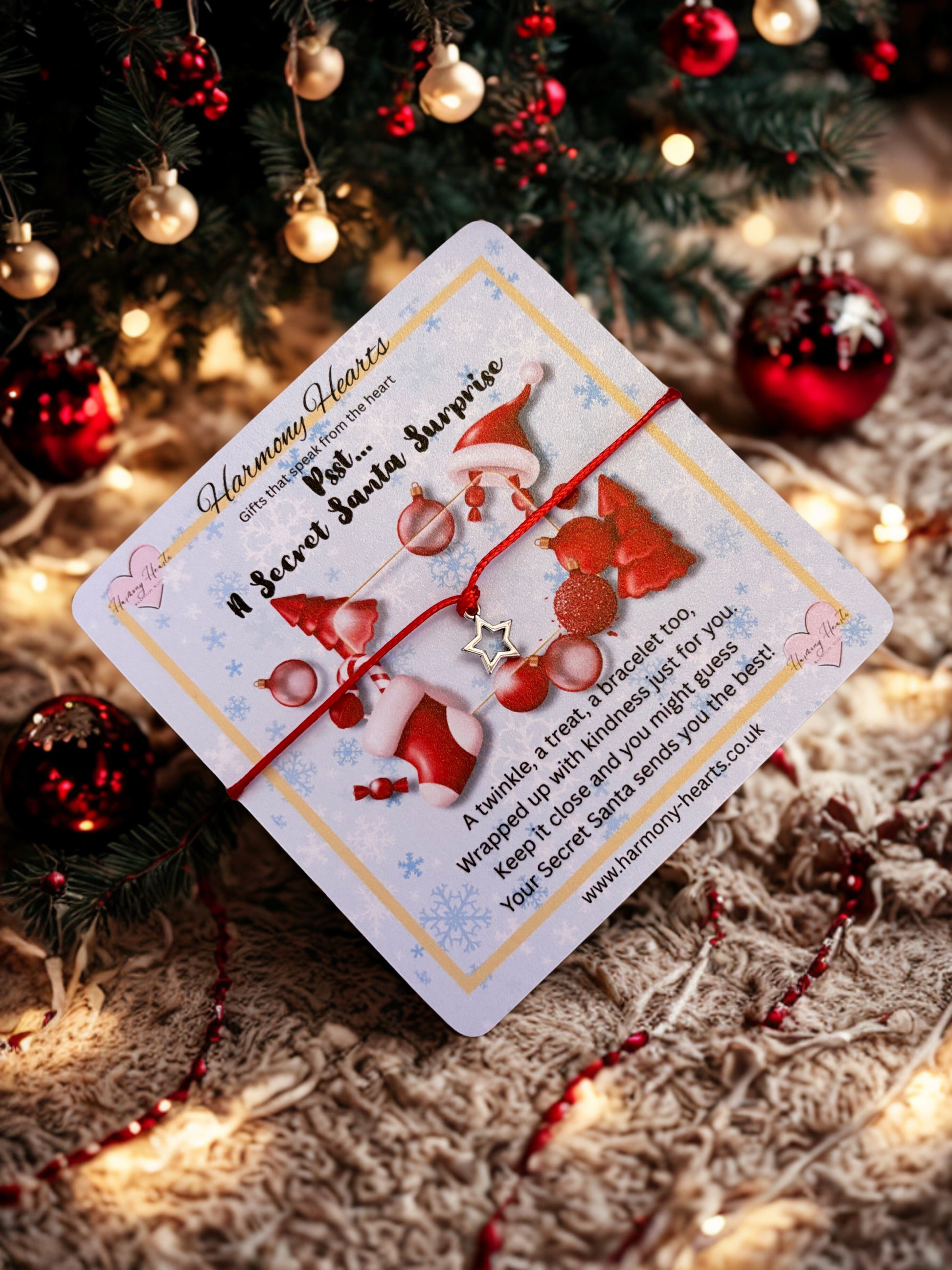 Card with Santa Claus design and a star charm bracelet on a Christmas-themed background