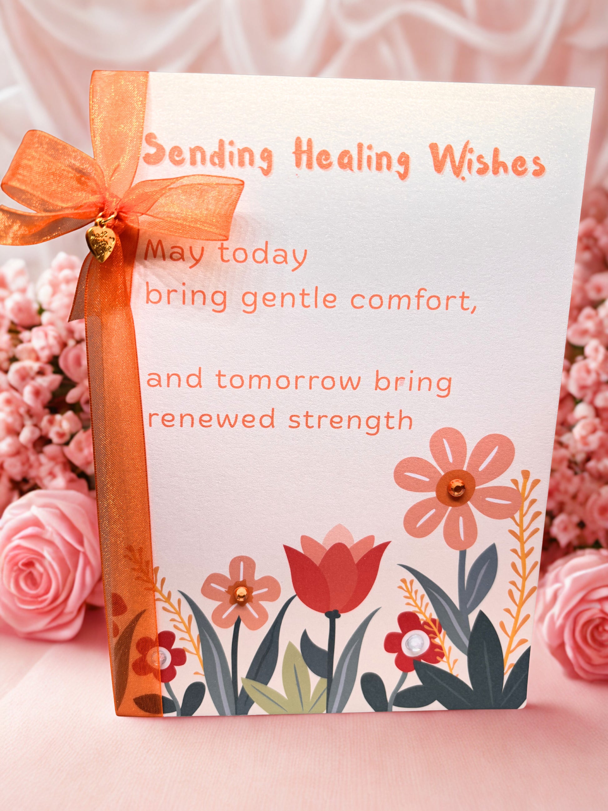 Get Well Greeting card with flowers and a ribbon on a pink floral background