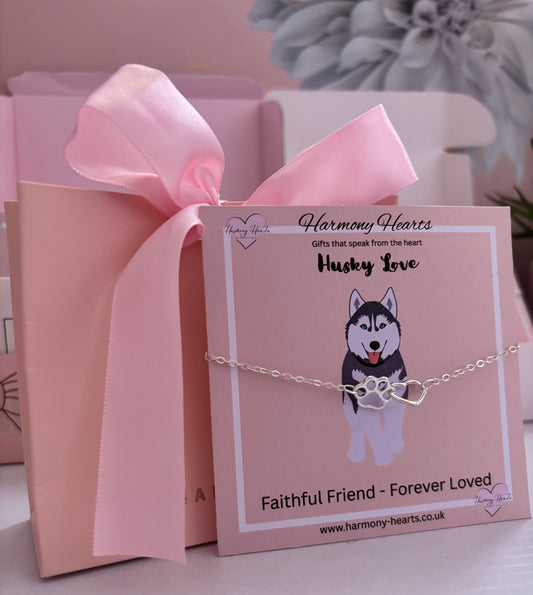 Pink gift box with a husky-themed bracelet and card, featuring 'Harmony Hearts' branding.