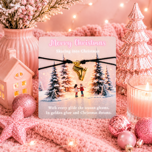 A Christmas-themed card displayed on pink holiday decor. The card reads 'Merry Christmas' and 'Skating into Christmas,' with a black cord bracelet across the front holding a gold ice skate charm.
