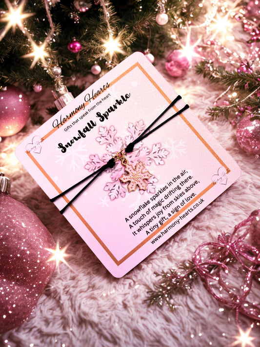 Snowflake charm bracelet with card on a festive background