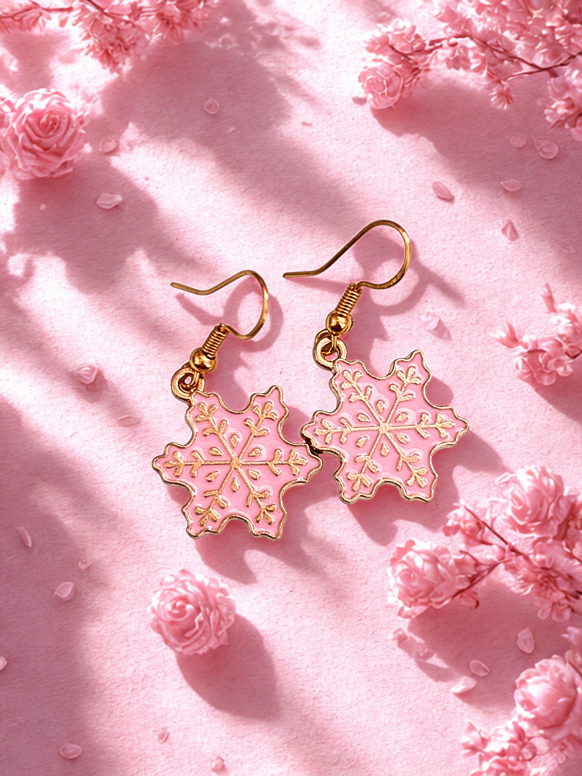 Pink snowflake earrings on a pink floral background
