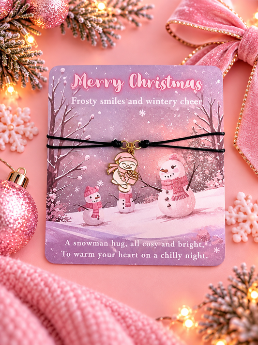 A Christmas-themed black cord bracelet with a snowman charm, presented on a printed holiday card. The card features a winter scene with snowmen and the text 'Merry Christmas'.
