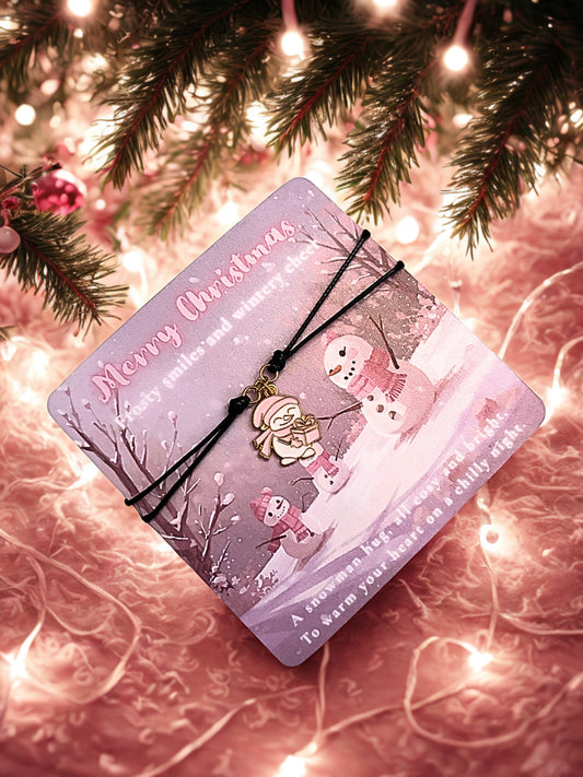 Pink Christmas card with snowman design on a festive background and a snowman charm bracelet