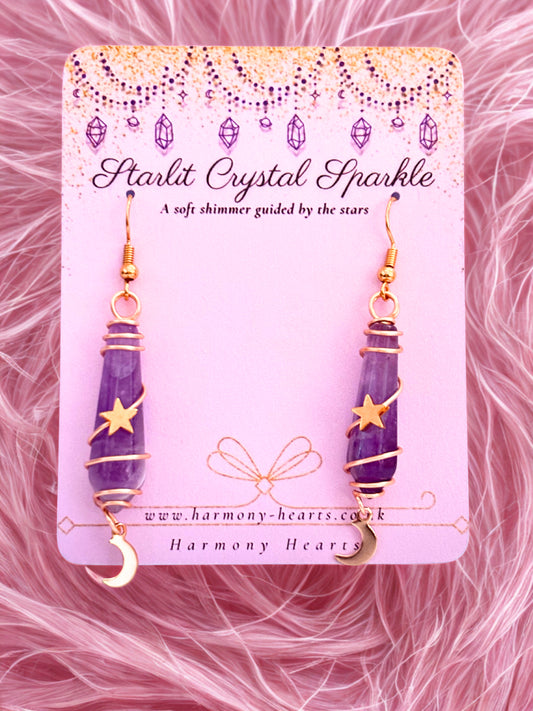 Purple amethyst crystal earrings on a pink card with 'Harmony Hearts' branding against a pink fur background.