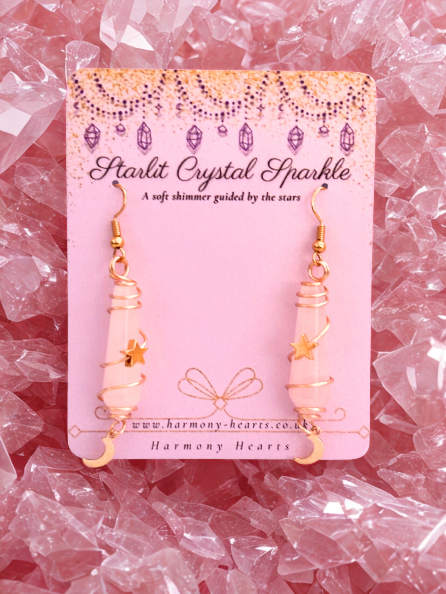 Starlit Crystal Sparkle earrings rose quartz on a pink card with decorative crystals in the background