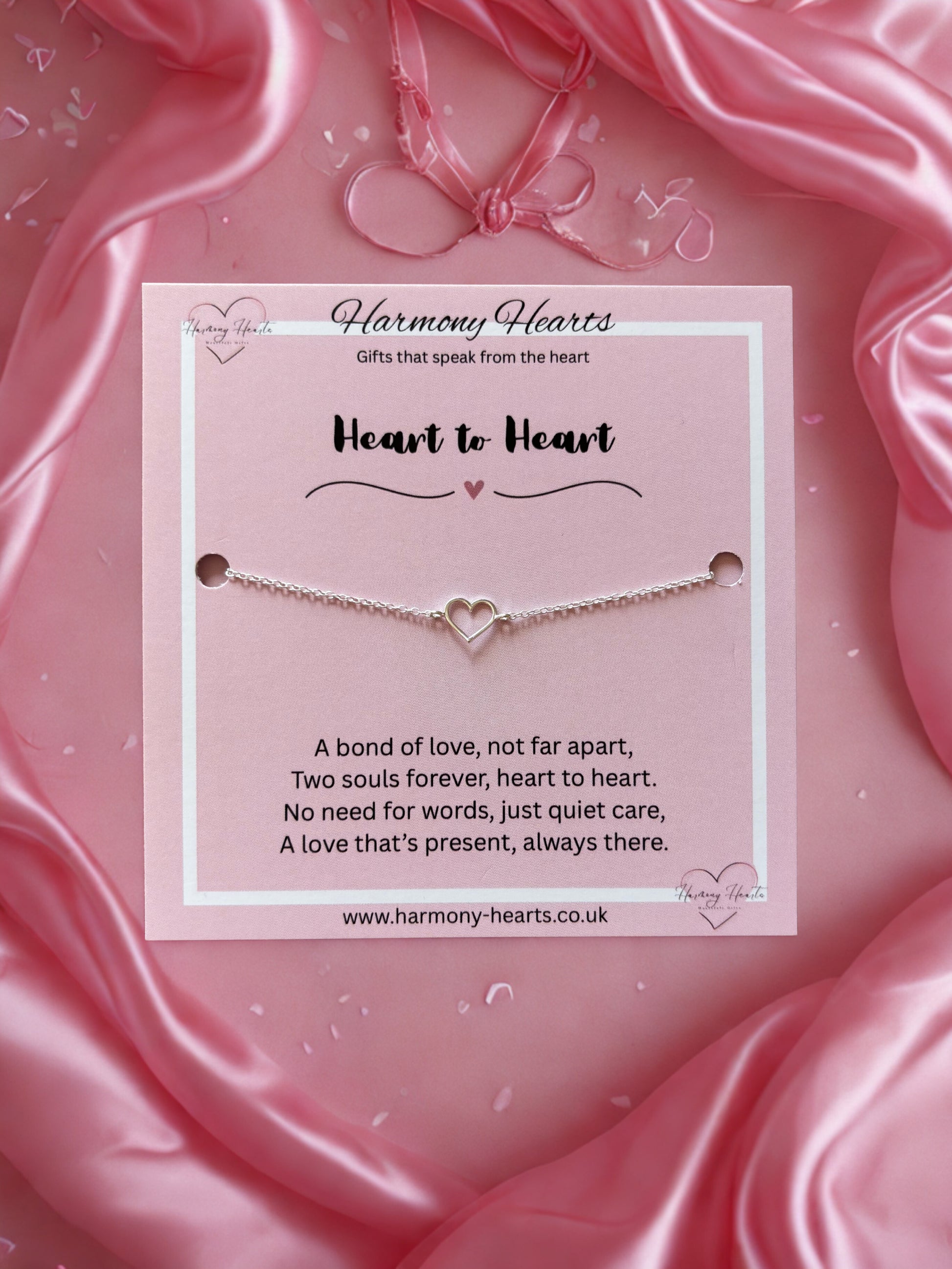 Heart-shaped bracelet on a pink card with 'Harmony Hearts' branding
