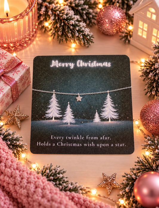 A delicate silver Christmas star bracelet displayed on a dark glittery card that reads 'Merry Christmas' and 'Every twinkle from afar. Holds a Christmas wish upon a star.