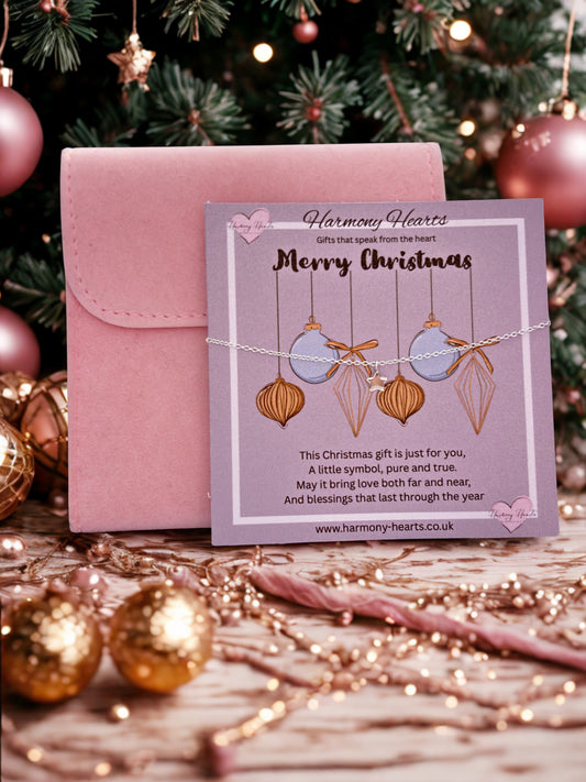 Pink jewelry box with a 'Merry Christmas' card featuring jewelry against a festive background.