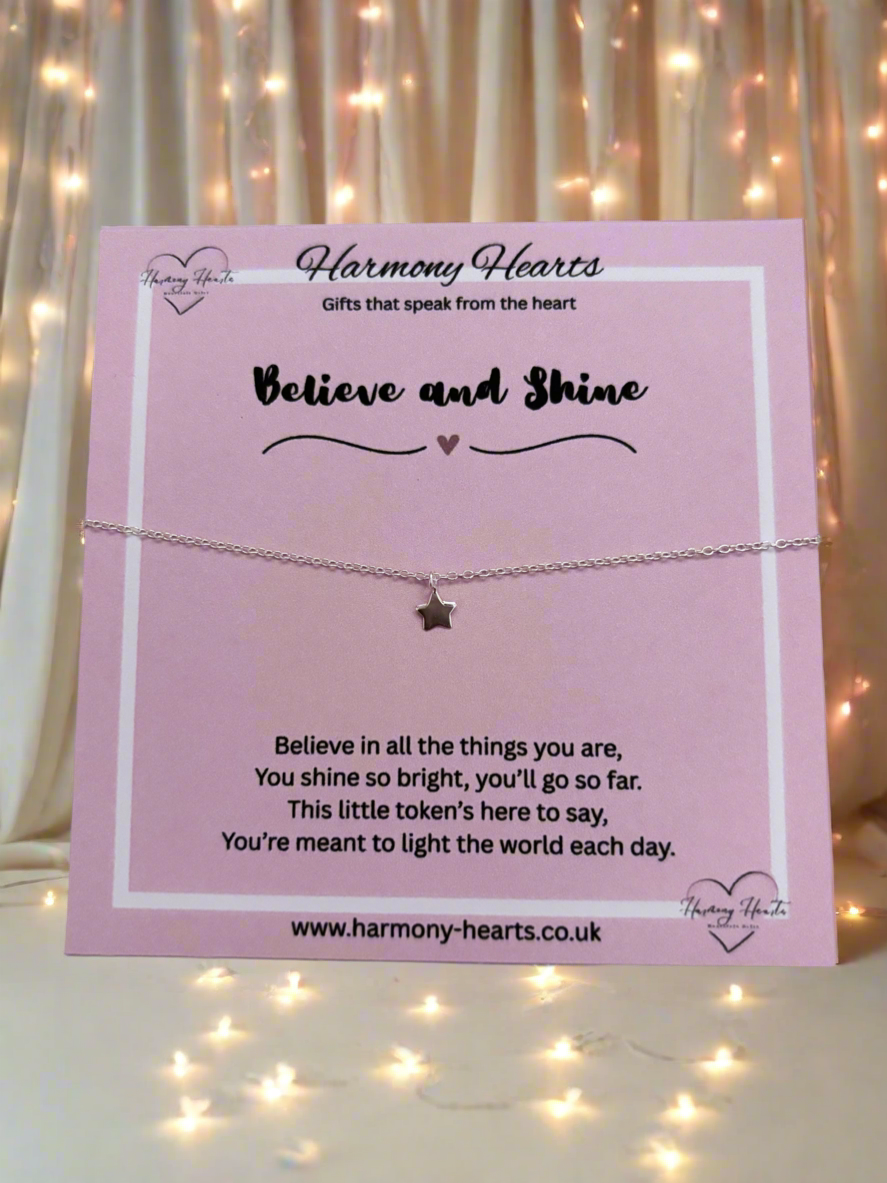 Bracelet with star charm on a pink card with 'Harmony Hearts' branding, set against a softly blurred light background.
