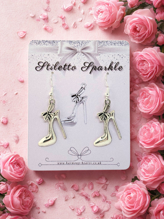 High-heeled shoe earrings on a 'Stiletto Sparkle' card with pink roses around.