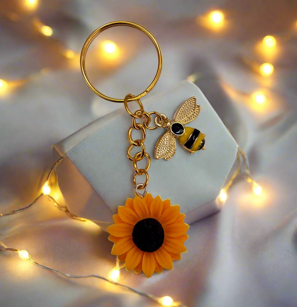 Keychain with bee and sunflower charm on a white background
