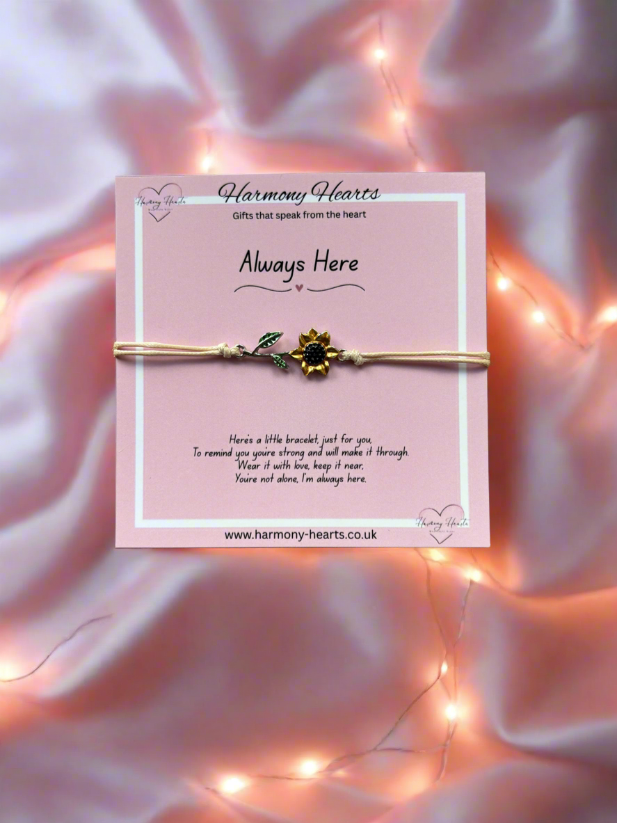 Bracelet on a pink card with 'Harmony Hearts' branding, set against a soft pink background with string lights.