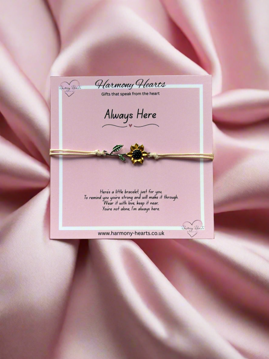 Bracelet on a pink card with 'Harmony Hearts' branding against a pink fabric background