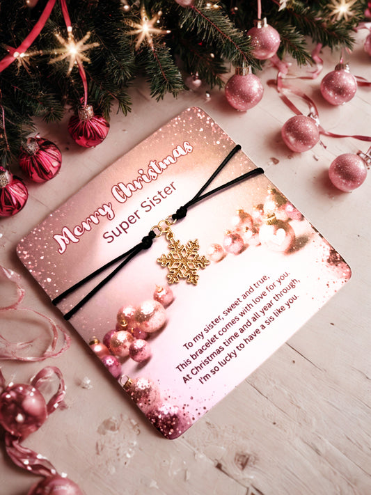 Pink card with 'Merry Christmas Super Sister' message and a snowflake bracelet with decorative elements on a festive background.