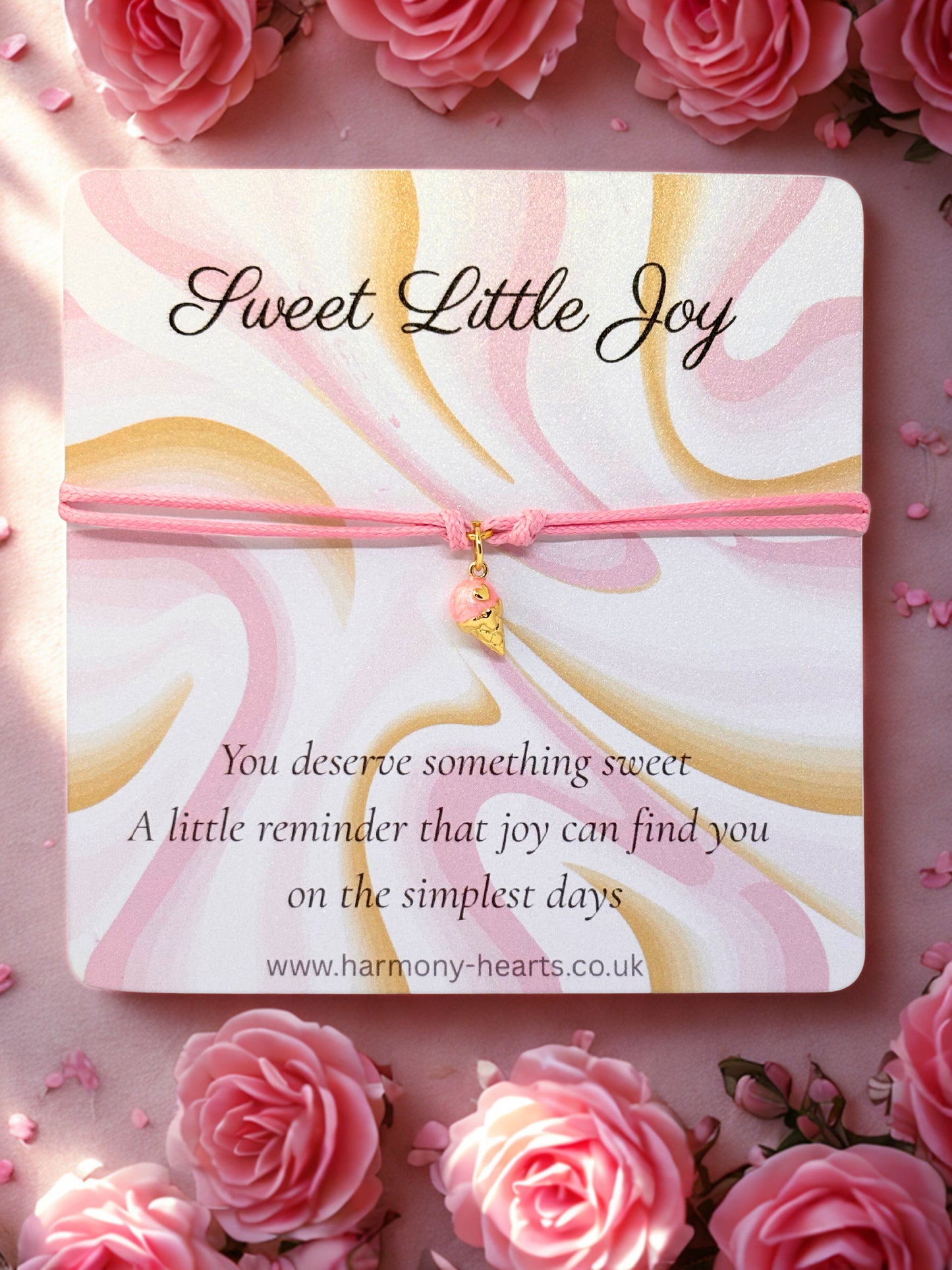 Pink cord charm bracelet with a pink and gold ice cream charm presented on a sweet little joy branded card by Harmony Hearts