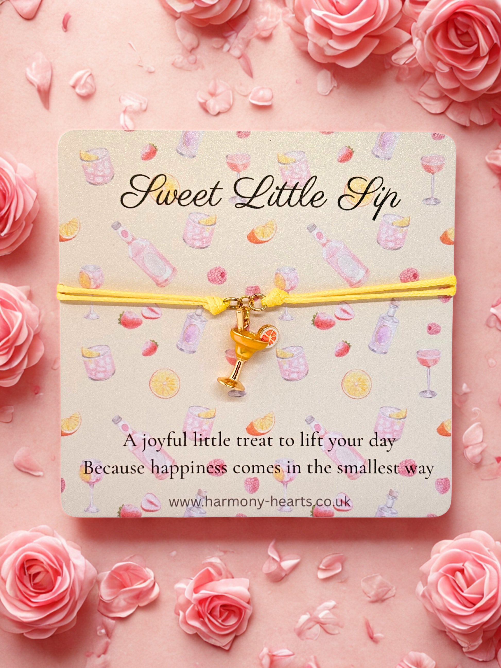 Branded Harmony Hearts card with 'Sweet Little Sip' text and a cocktail charm bracelet on a pink floral background