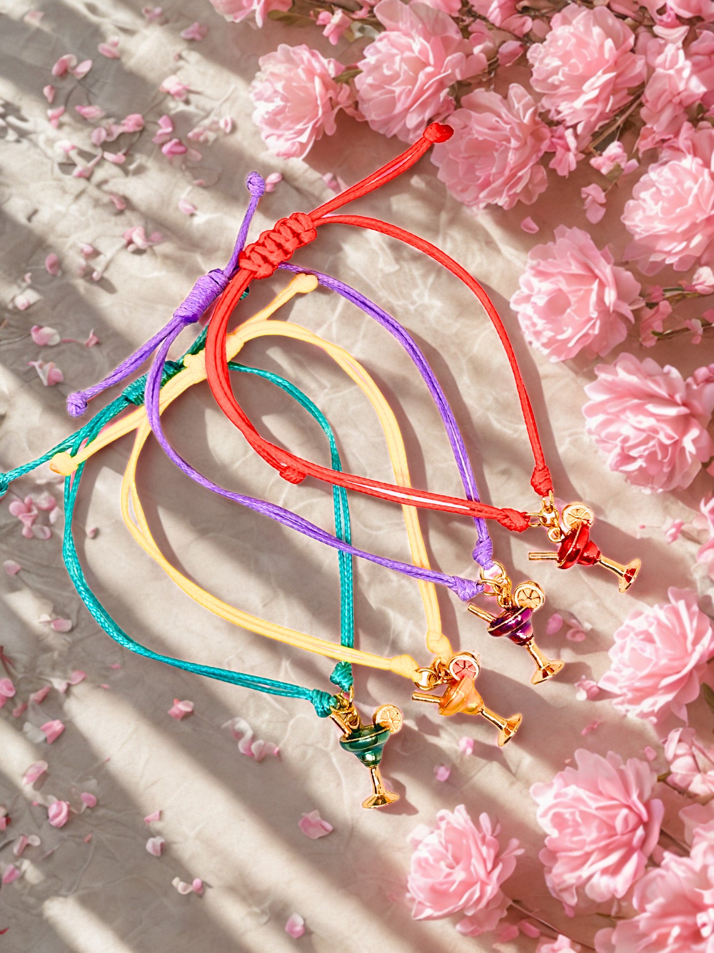 Colorful cocktail charm bracelets on a floral background