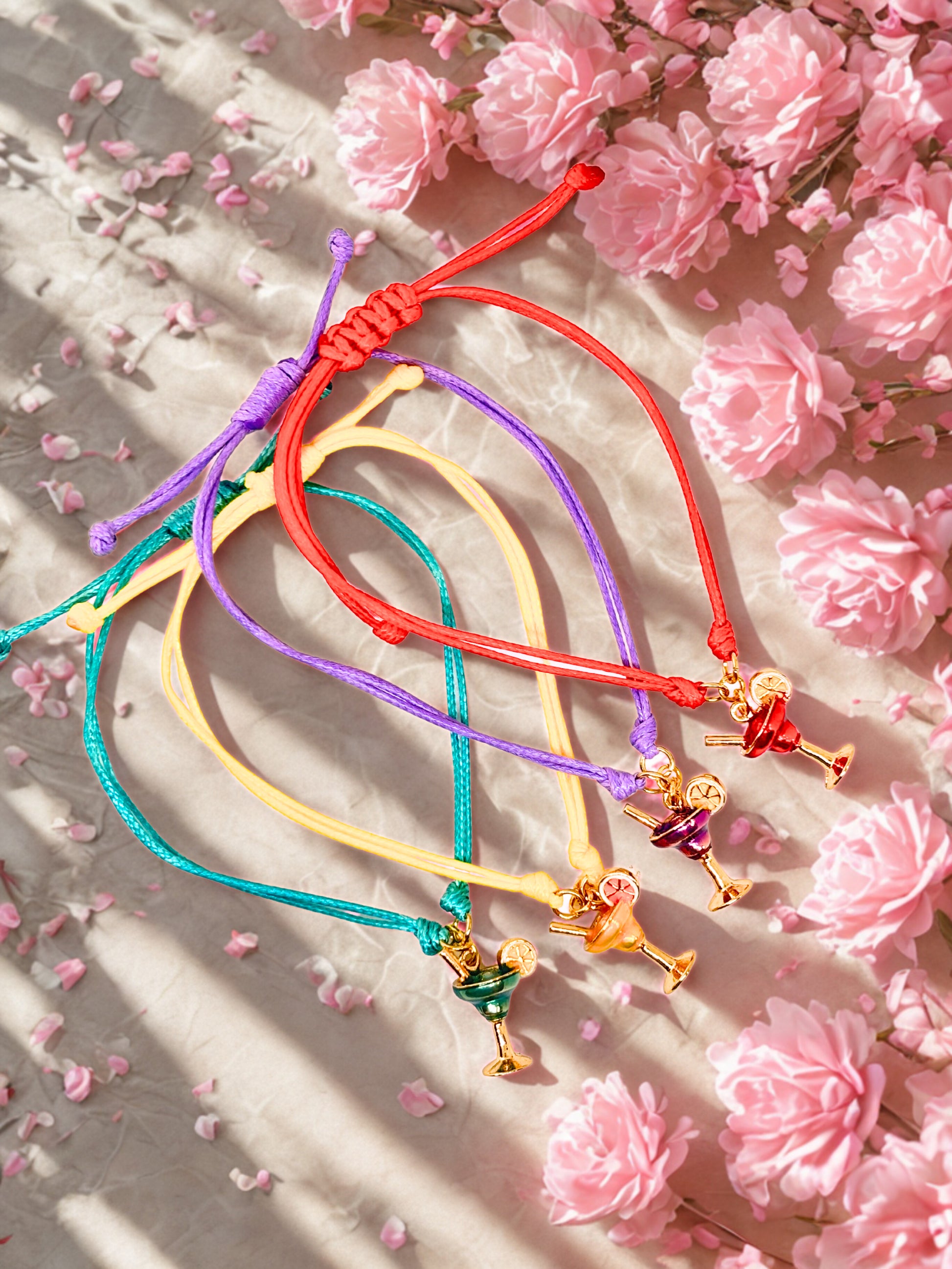 Colorful cocktail charm bracelets on a floral background