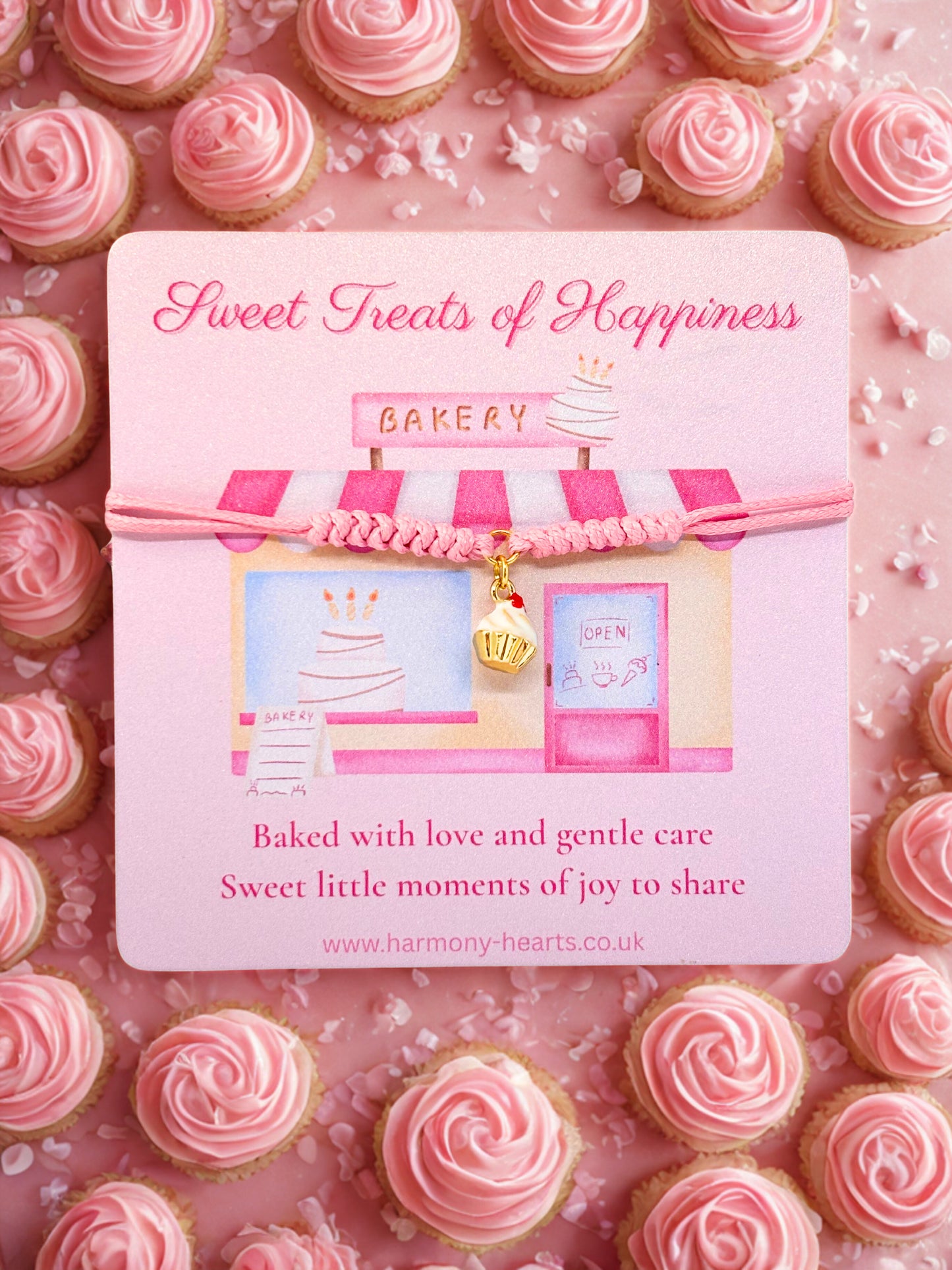 Cupcake charm bracelet presented on a Bakery-themed card with pink cookies and 'Sweet Treats of Happiness' Harmony Hearts