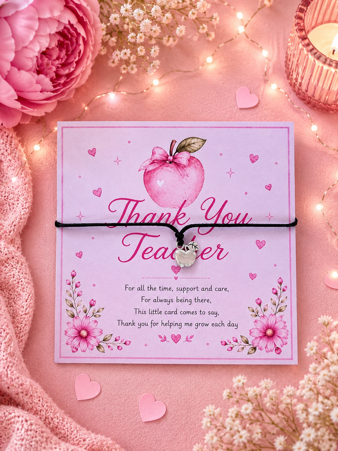 Bracelet on a Pink 'Thank You Teacher' card with decorative elements on a pink background with flowers and lights.